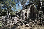 Ta Prohm temple - the badly ruined gopura of the gallery first found entering the site from west 
